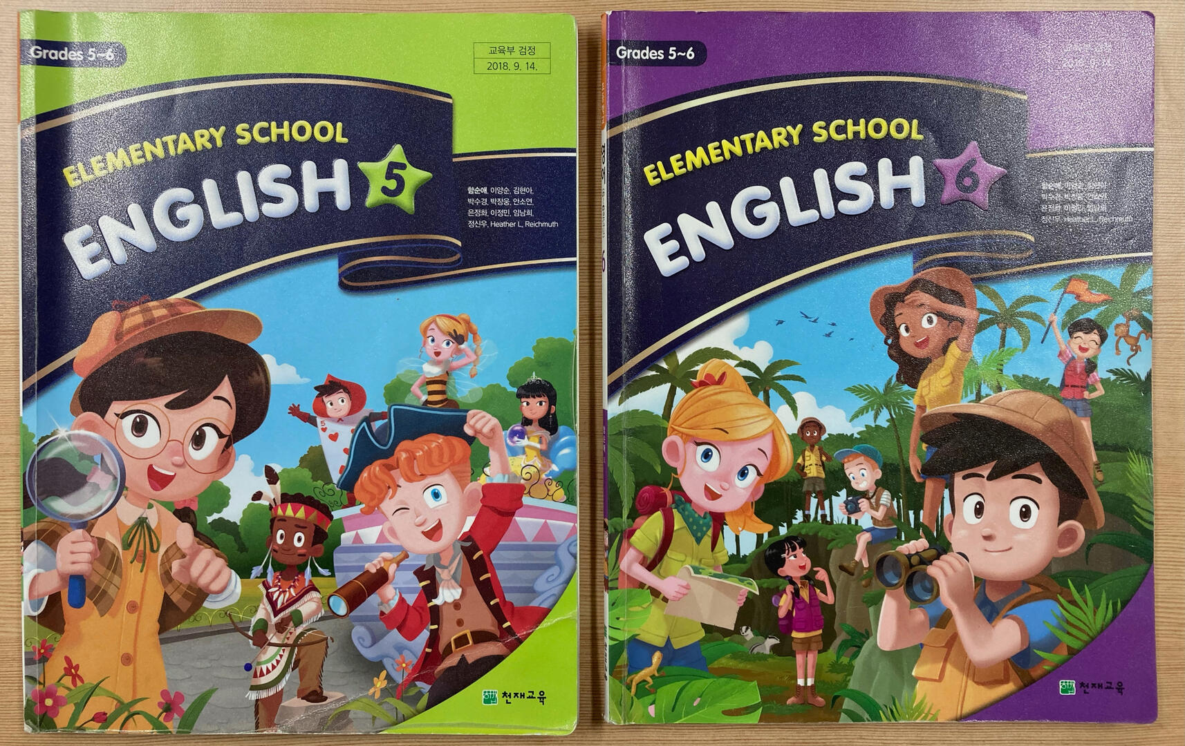 Two more Cheonjae textbooks on a table. The one mentioned for this lesson is in this picture, as well as the other for 6th grade.